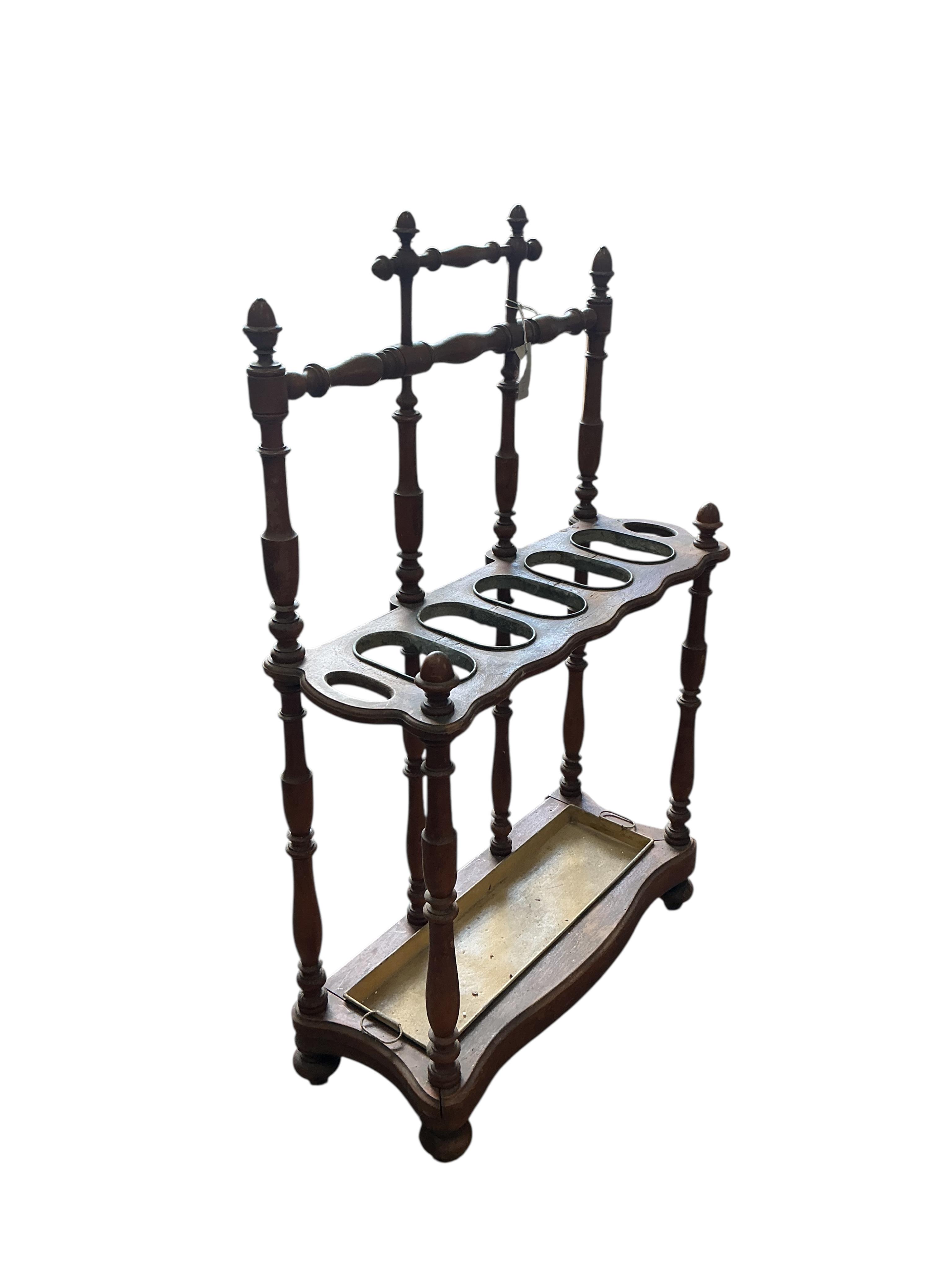 A late 19th / early 20th century French turned fruitwood five division stick stand, with tin drip tray, width 72cm, depth 28cm, height 112cm
